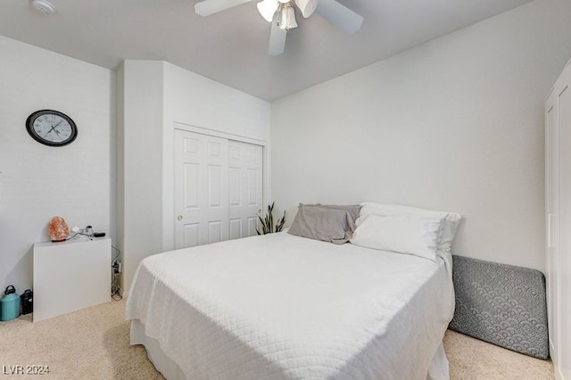 bedroom featuring a closet, ceiling fan, and light carpet