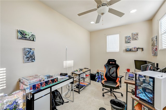 carpeted office with a healthy amount of sunlight and ceiling fan