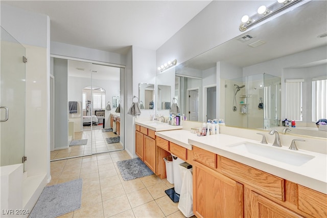 bathroom featuring tile patterned flooring, walk in shower, and vanity