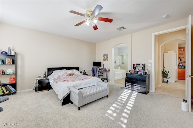 carpeted bedroom with ceiling fan and ensuite bathroom