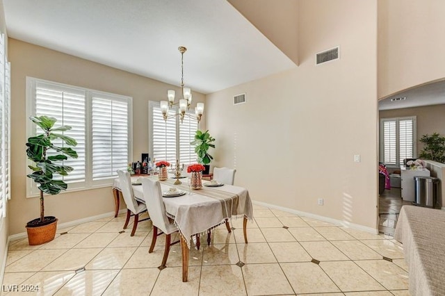 dining area with a chandelier and light tile patterned flooring