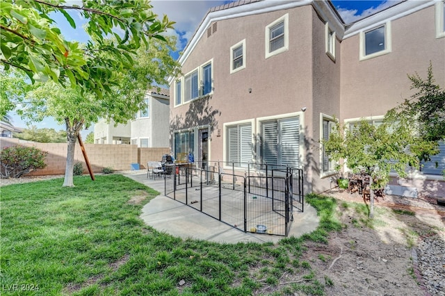 back of house with a yard and a patio area