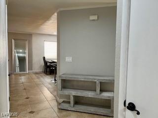 hall featuring light tile patterned flooring