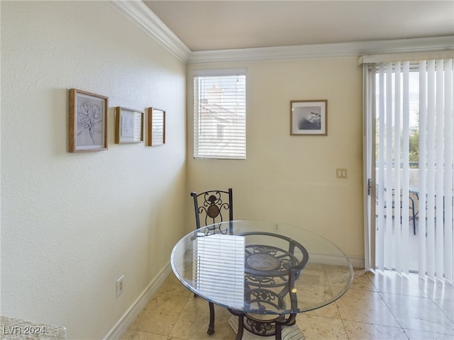 dining area with light tile patterned flooring and ornamental molding