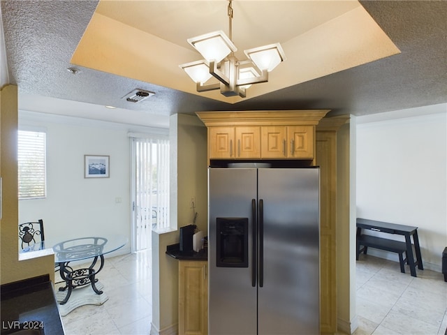 kitchen with a textured ceiling, stainless steel fridge, light brown cabinets, and light tile patterned flooring