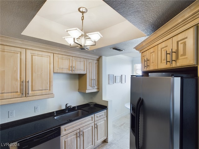 kitchen with light brown cabinetry, appliances with stainless steel finishes, a notable chandelier, sink, and a textured ceiling