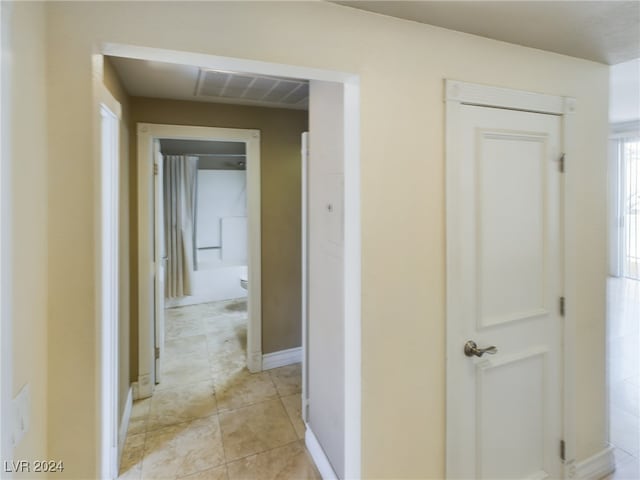 hallway featuring light tile patterned floors