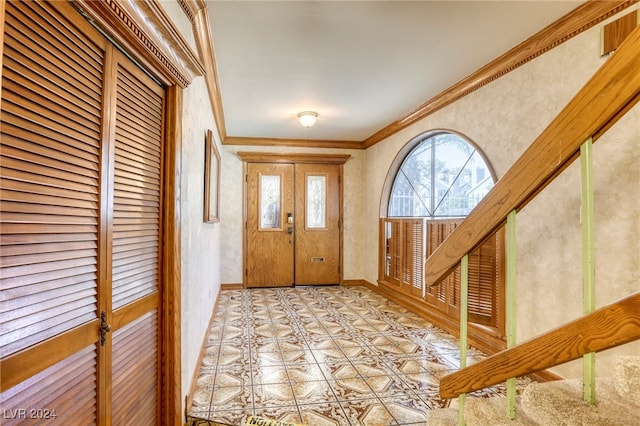 entrance foyer featuring crown molding