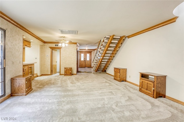 unfurnished living room with light carpet, a ceiling fan, visible vents, baseboards, and ornamental molding