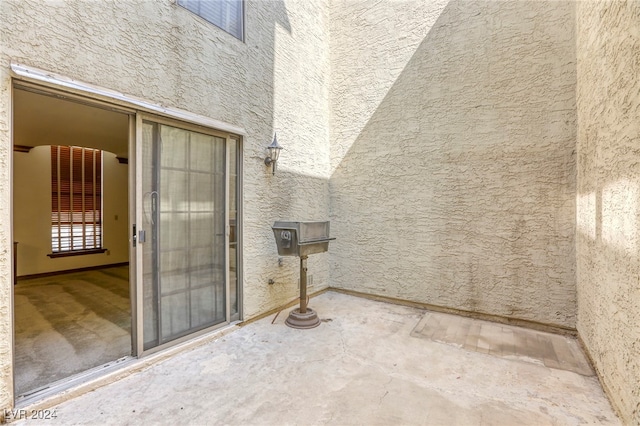 exterior space with a patio area and stucco siding