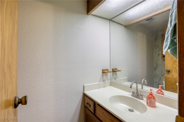 bathroom featuring vanity and a textured ceiling