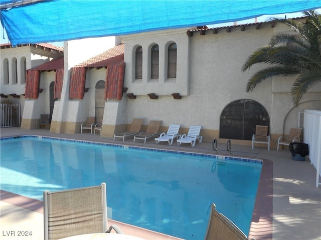 community pool with a patio area