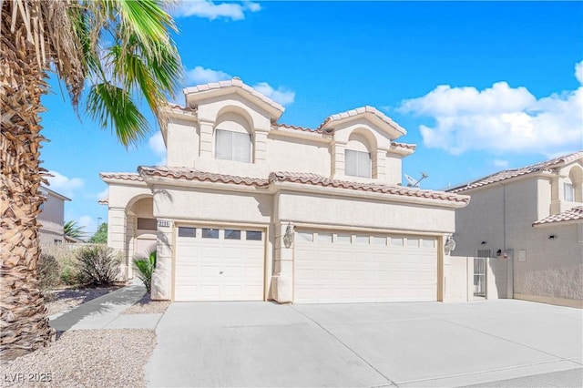 mediterranean / spanish-style home with a garage