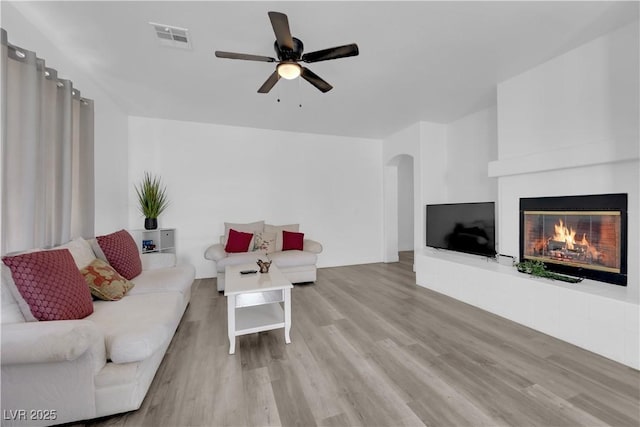 living room with ceiling fan and light hardwood / wood-style floors