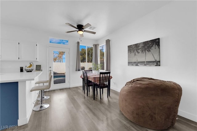 dining area with hardwood / wood-style flooring and ceiling fan