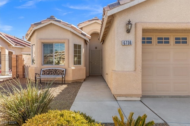 view of exterior entry featuring a garage