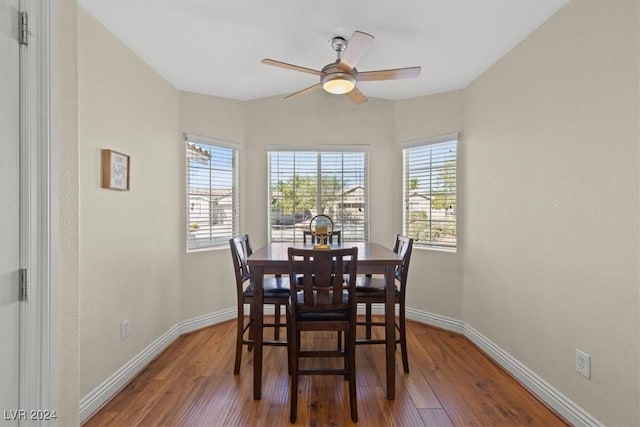 dining space with ceiling fan, baseboards, and wood finished floors