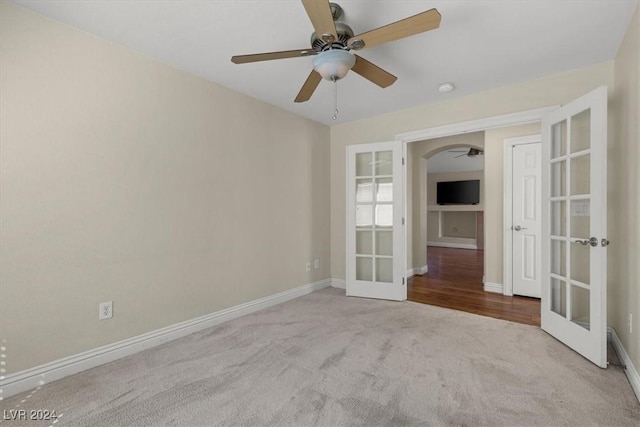 carpeted spare room with french doors and baseboards