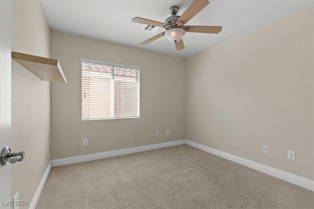 spare room featuring carpet floors, visible vents, ceiling fan, and baseboards