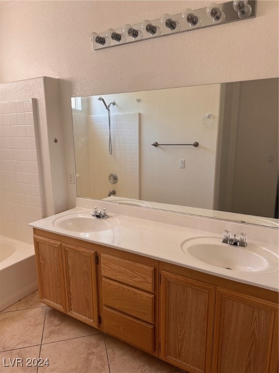 bathroom featuring tile patterned flooring, washtub / shower combination, and vanity