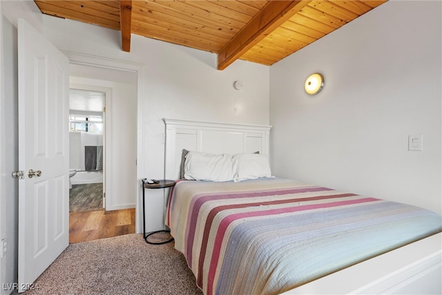 carpeted bedroom with wooden ceiling, beam ceiling, and connected bathroom