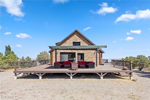 back of house featuring a deck and an outdoor living space