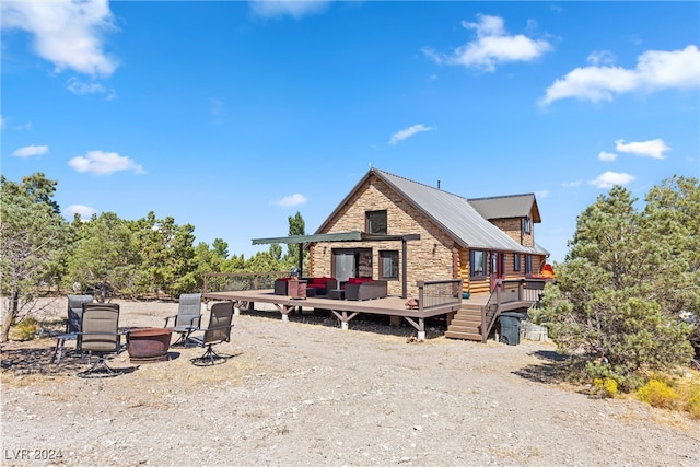 view of front facade featuring an outdoor fire pit and a wooden deck