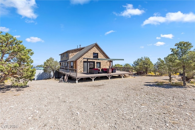 rear view of property with a wooden deck