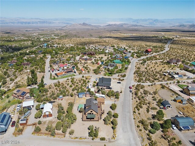 birds eye view of property with a mountain view