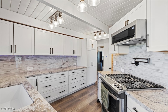 kitchen with stainless steel appliances, white cabinets, dark hardwood / wood-style flooring, and tasteful backsplash