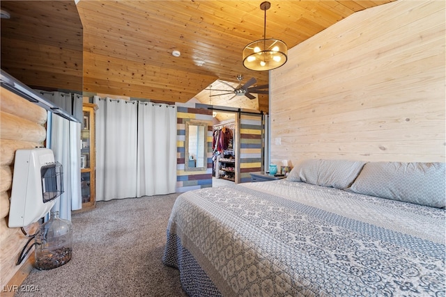 unfurnished bedroom featuring a closet, heating unit, a barn door, wooden walls, and wood ceiling