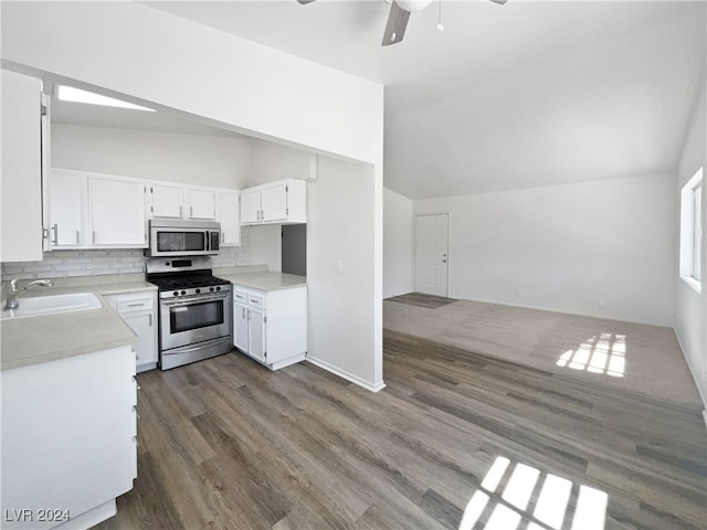 kitchen featuring lofted ceiling, appliances with stainless steel finishes, ceiling fan, and sink