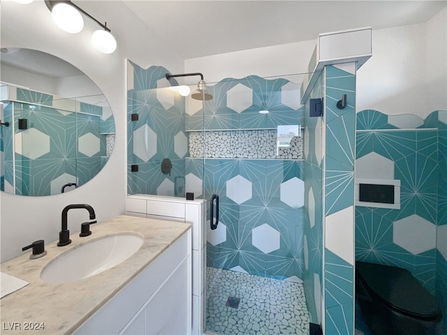 bathroom featuring vanity and a shower with door