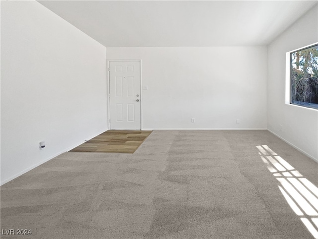 unfurnished room with light colored carpet