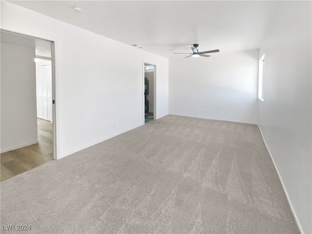 carpeted empty room with ceiling fan