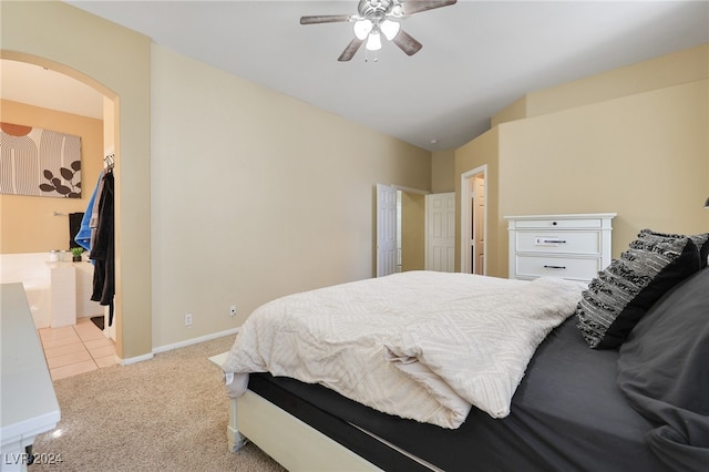 bedroom with light colored carpet, vaulted ceiling, and ceiling fan