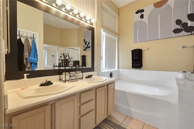 bathroom with tile patterned flooring, separate shower and tub, and vanity