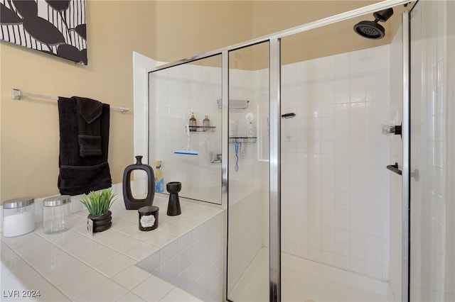 bathroom featuring a shower with shower door