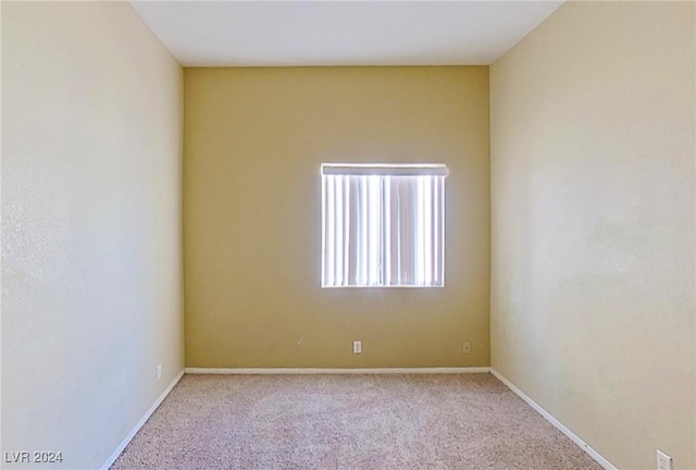 empty room featuring light colored carpet