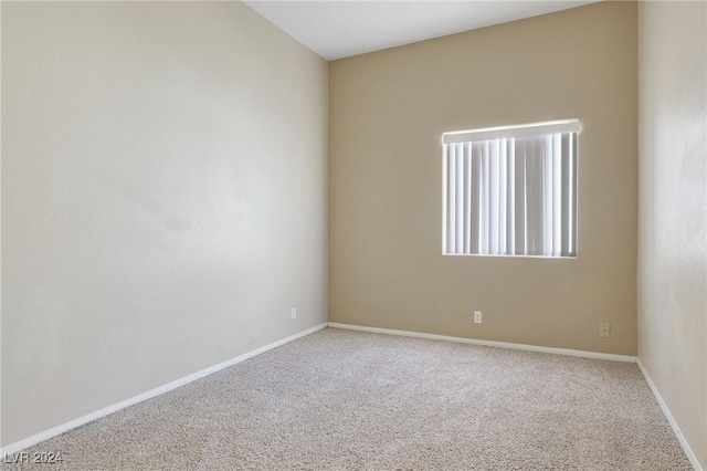 carpeted empty room with baseboards