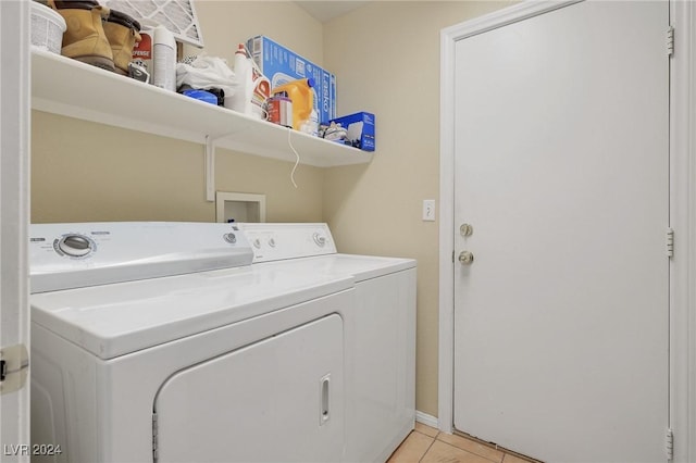 laundry room with laundry area, light tile patterned floors, and washing machine and dryer