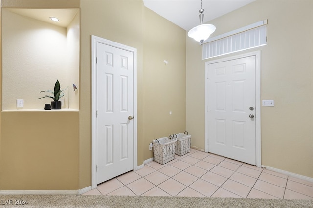 view of carpeted foyer entrance