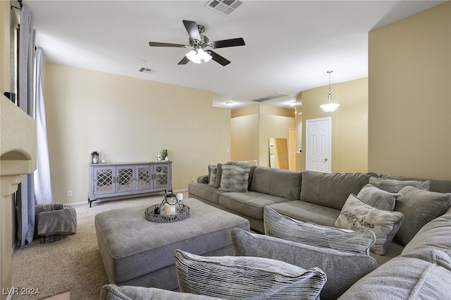 carpeted living room featuring ceiling fan and a fireplace