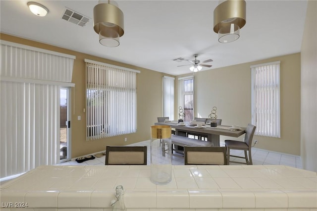 dining space featuring ceiling fan, visible vents, and plenty of natural light