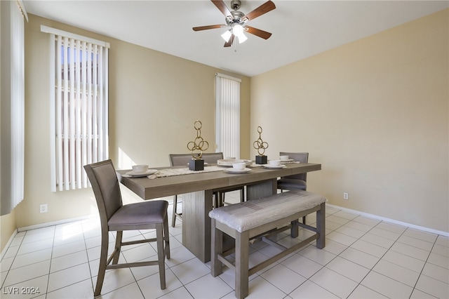 tiled dining space featuring ceiling fan