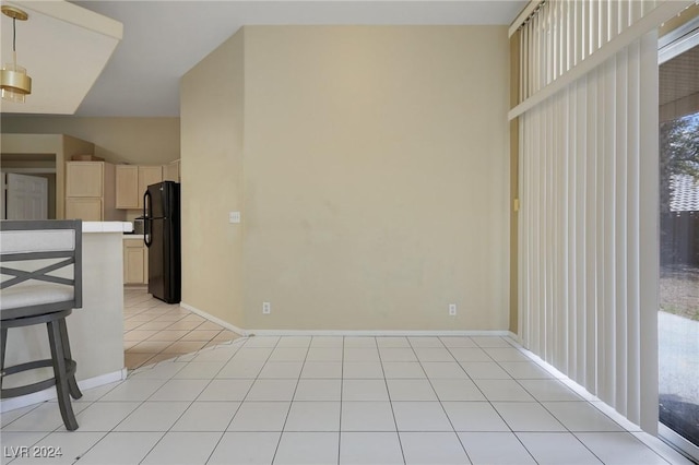 interior space with baseboards and light tile patterned floors