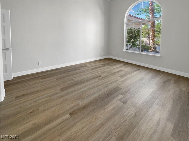 unfurnished room featuring dark hardwood / wood-style floors