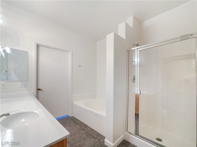 bathroom with tile patterned flooring, independent shower and bath, and vanity