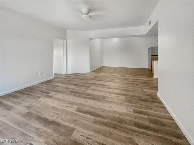 empty room with light wood-type flooring and ceiling fan