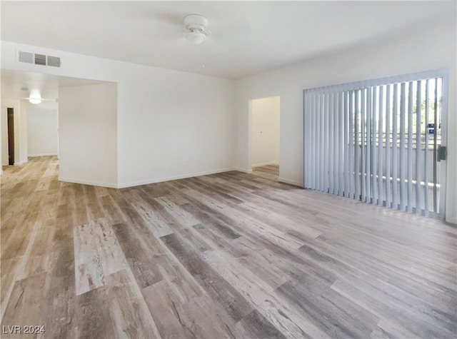 unfurnished room with ceiling fan and light wood-type flooring